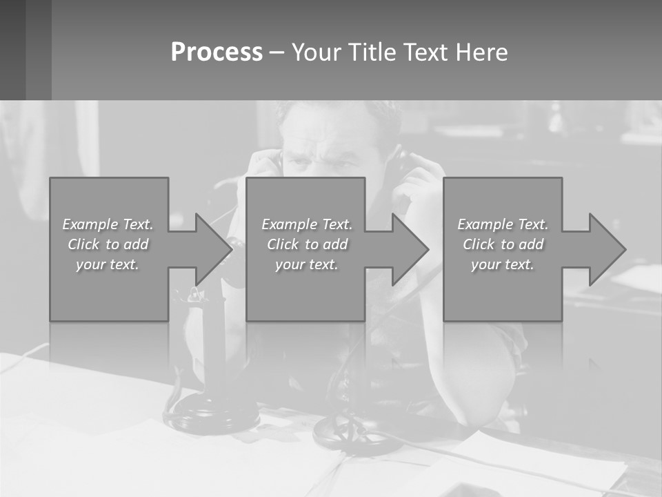 A Man Sitting At A Desk Talking On A Phone PowerPoint Template