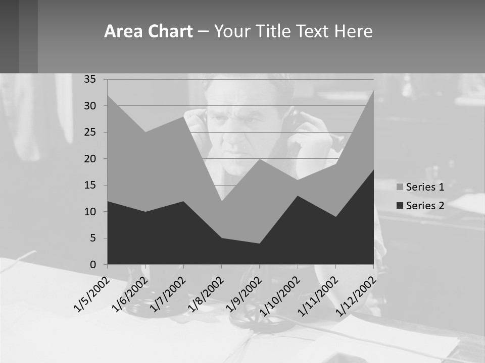 A Man Sitting At A Desk Talking On A Phone PowerPoint Template
