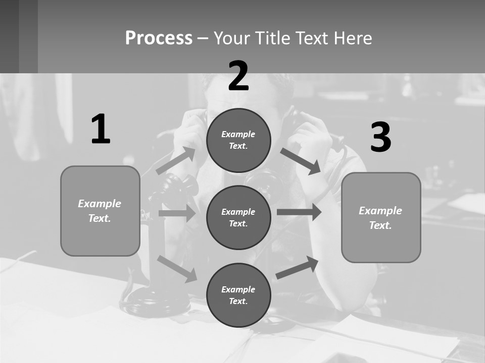 A Man Sitting At A Desk Talking On A Phone PowerPoint Template
