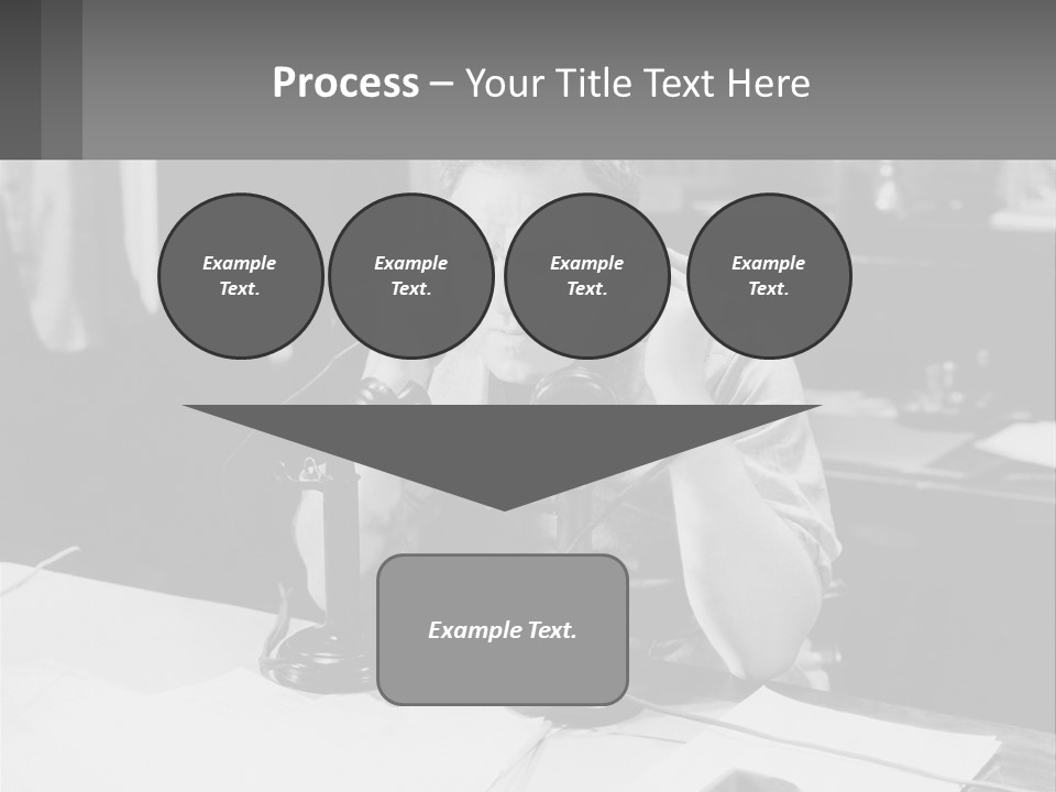 A Man Sitting At A Desk Talking On A Phone PowerPoint Template