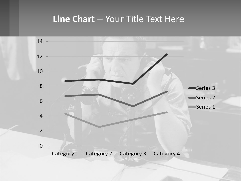 A Man Sitting At A Desk Talking On A Phone PowerPoint Template