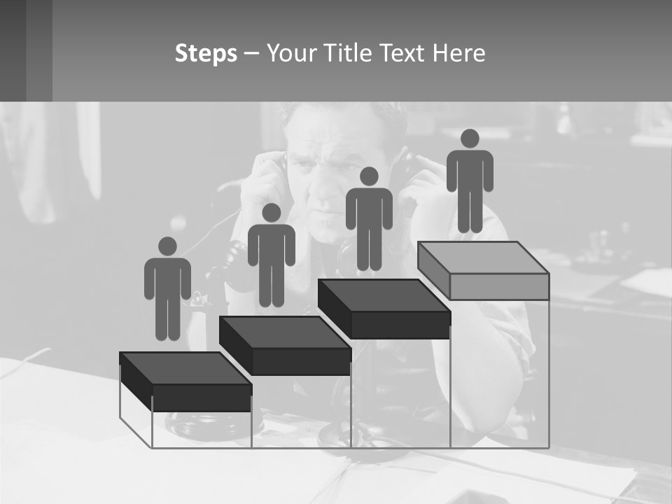 A Man Sitting At A Desk Talking On A Phone PowerPoint Template