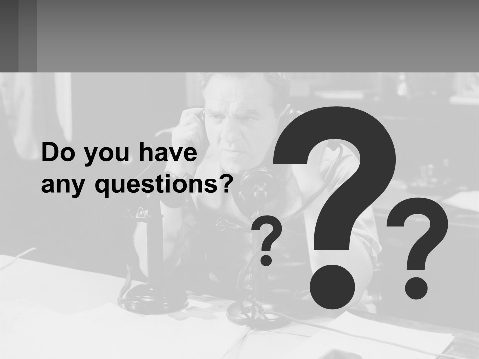 A Man Sitting At A Desk Talking On A Phone PowerPoint Template