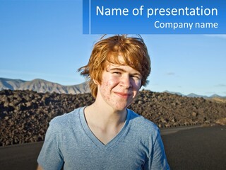 A Young Boy Standing In Front Of A Mountain PowerPoint Template