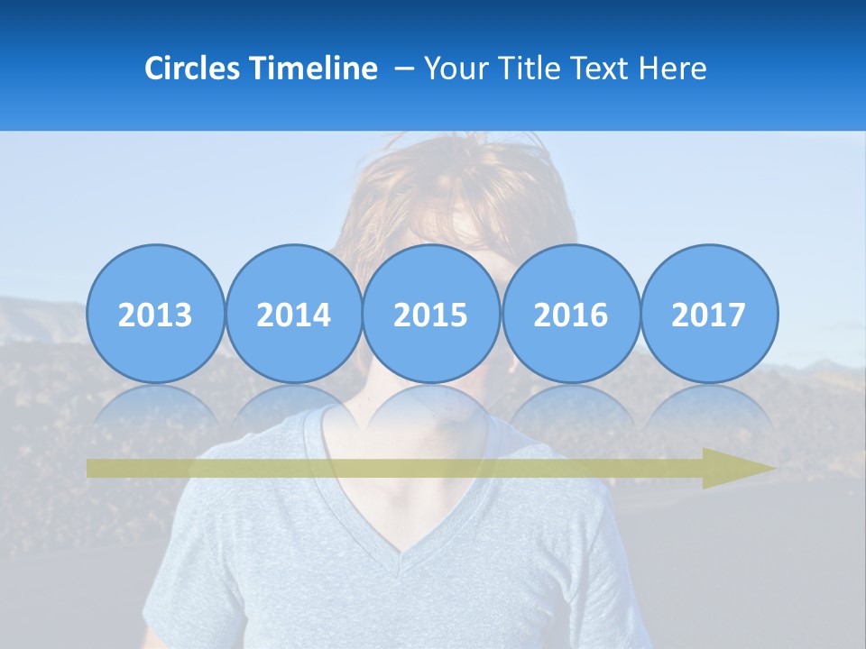 A Young Boy Standing In Front Of A Mountain PowerPoint Template