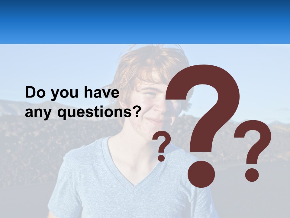 A Young Boy Standing In Front Of A Mountain PowerPoint Template