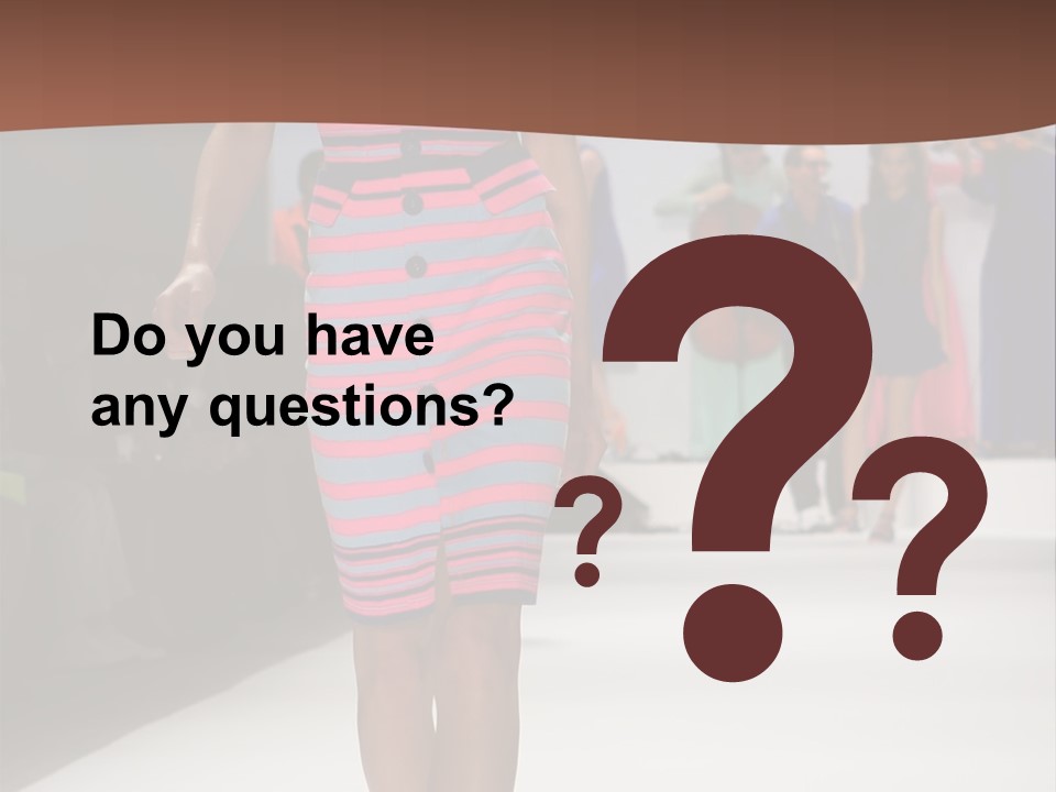 A Woman Walking Down A Runway In A Colorful Dress PowerPoint Template