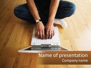 A Person Sitting On The Floor Using A Laptop PowerPoint Template