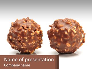 Two Chocolate Balls With Nuts On Top Of Them PowerPoint Template