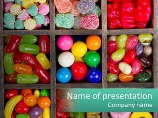 A Wooden Box Filled With Lots Of Candy PowerPoint Template