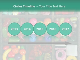 A Wooden Box Filled With Lots Of Candy PowerPoint Template