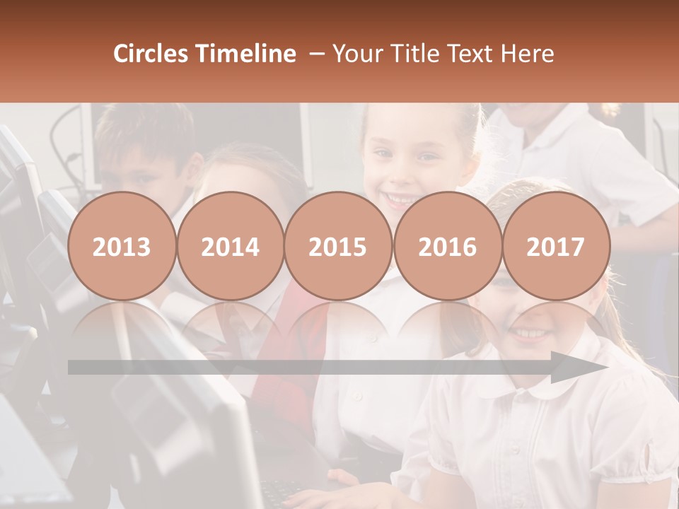 A Group Of Children Sitting In Front Of A Computer PowerPoint Template