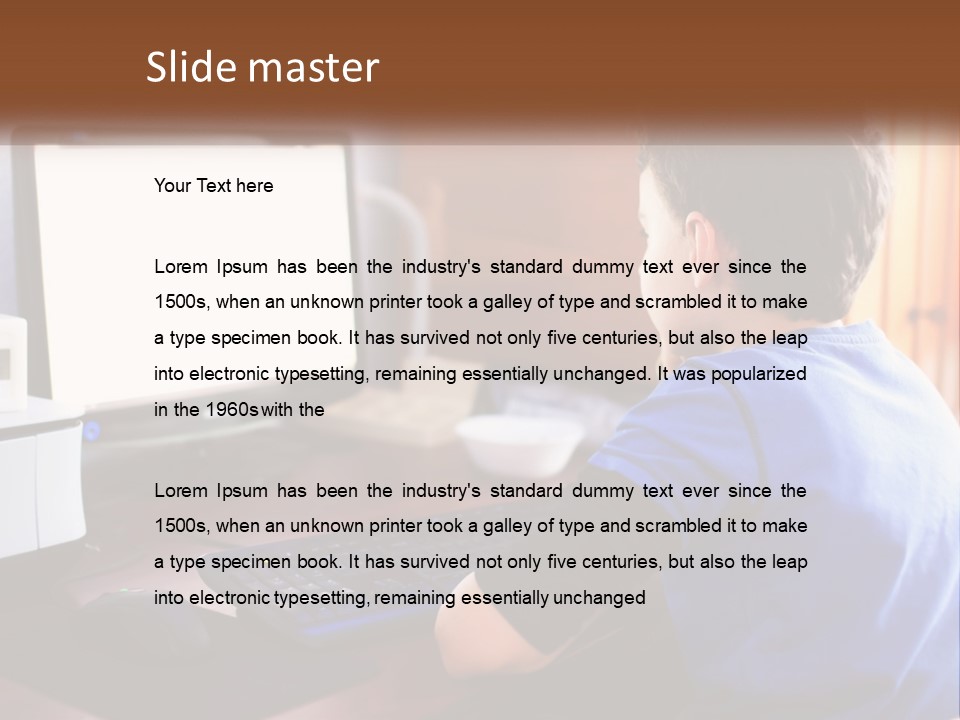 A Young Boy Sitting At A Desk With A Computer PowerPoint Template