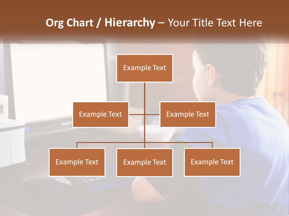 A Young Boy Sitting At A Desk With A Computer PowerPoint Template