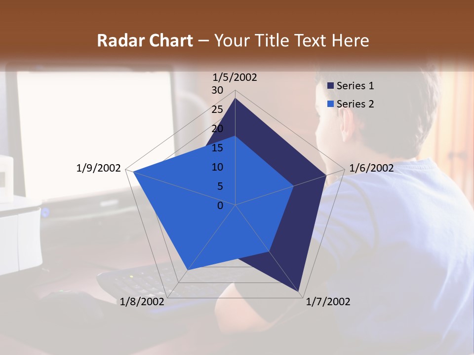 A Young Boy Sitting At A Desk With A Computer PowerPoint Template