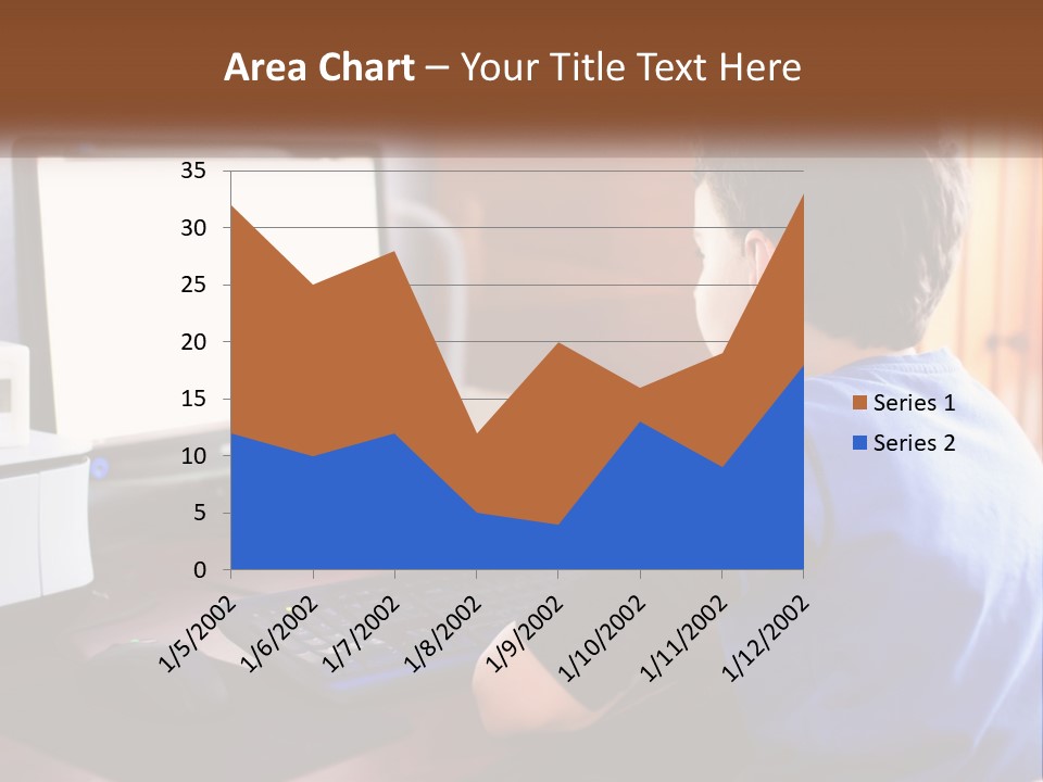 A Young Boy Sitting At A Desk With A Computer PowerPoint Template