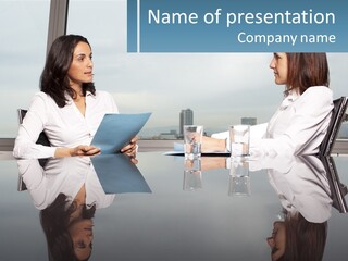 Two Women Sitting At A Table With Papers In Front Of Them PowerPoint Template