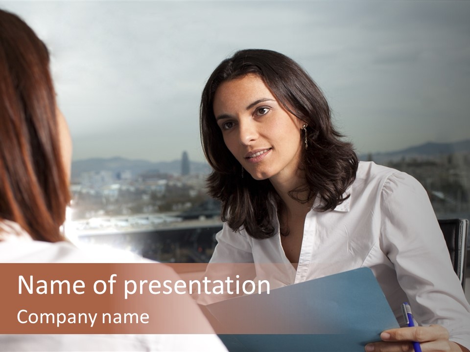 A Woman Sitting At A Desk Talking To Another Woman PowerPoint Template