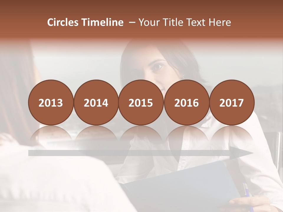 A Woman Sitting At A Desk Talking To Another Woman PowerPoint Template