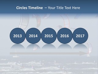 A Group Of Kites Being Flown Over The Ocean PowerPoint Template