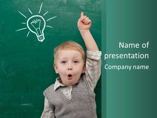 A Young Boy Pointing At A Light Bulb On A Chalkboard PowerPoint Template