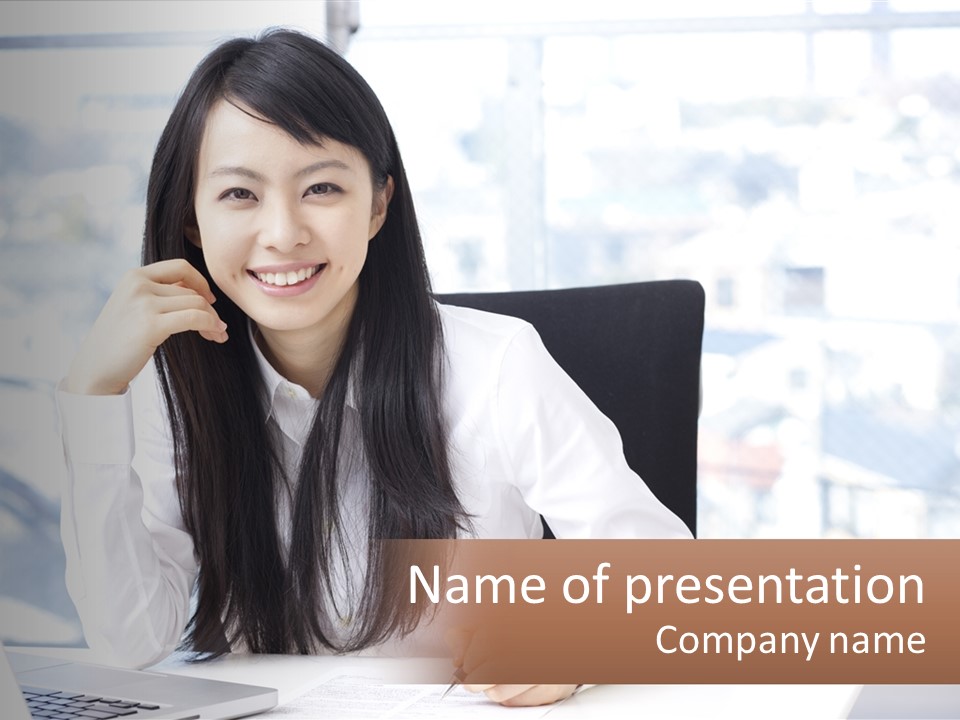 A Woman Sitting At A Desk In Front Of A Laptop Computer PowerPoint Template