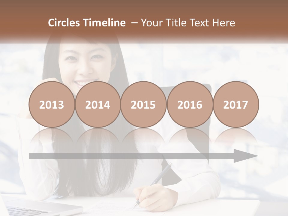 A Woman Sitting At A Desk In Front Of A Laptop Computer PowerPoint Template