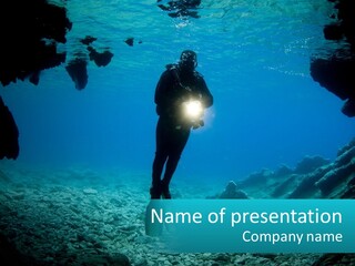 A Scuba Diver With A Light In The Water PowerPoint Template