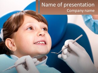 A Young Boy Getting His Teeth Checked By A Dentist PowerPoint Template