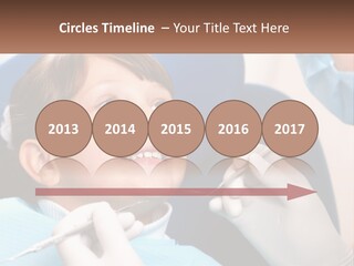 A Young Boy Getting His Teeth Checked By A Dentist PowerPoint Template