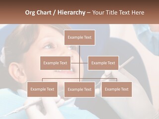 A Young Boy Getting His Teeth Checked By A Dentist PowerPoint Template