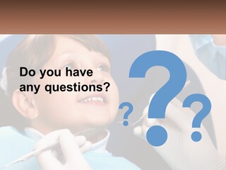 A Young Boy Getting His Teeth Checked By A Dentist PowerPoint Template