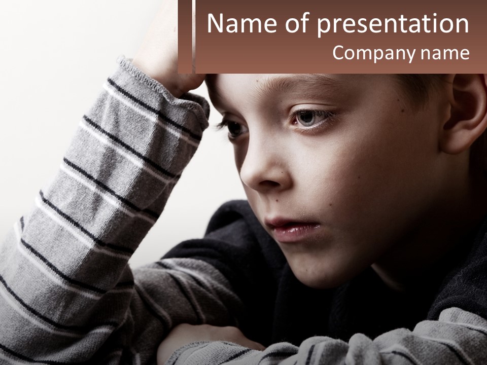 A Young Boy Holding His Head In His Hands PowerPoint Template