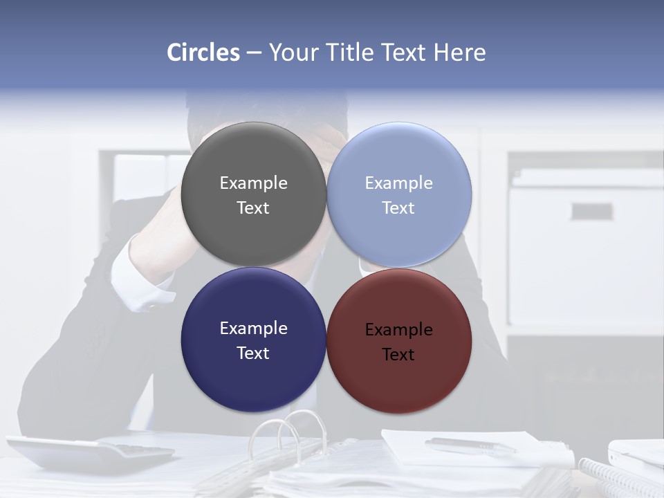 A Man Sitting At A Desk With His Hands On His Head PowerPoint Template