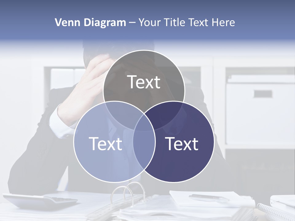A Man Sitting At A Desk With His Hands On His Head PowerPoint Template