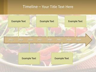 A Salad With Tomatoes And Lettuce On A Plate With A Fork PowerPoint Template