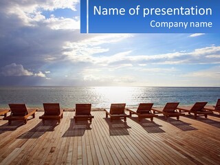 A Group Of Lounge Chairs Sitting On Top Of A Wooden Pier PowerPoint Template