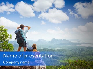 A Couple Of People Standing On Top Of A Mountain PowerPoint Template