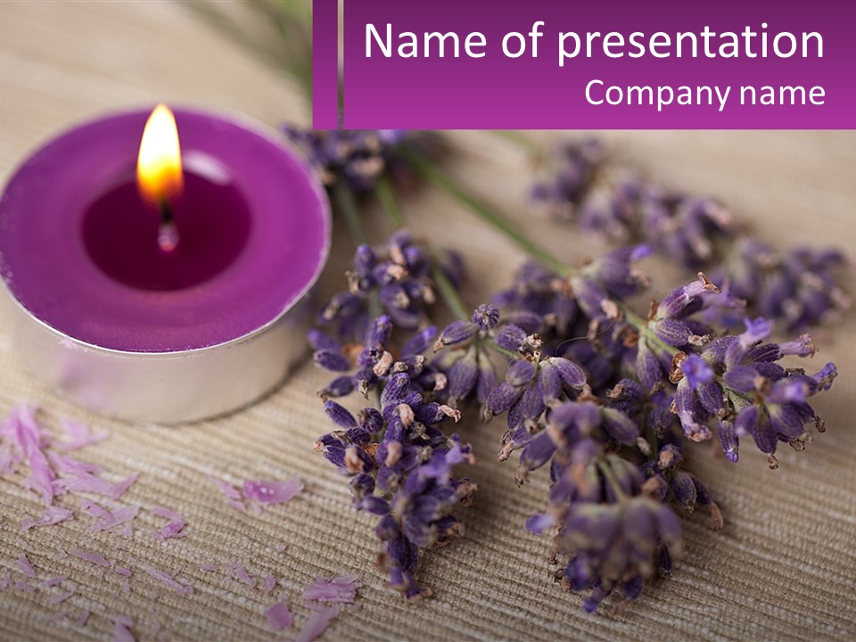 A Purple Candle And Some Lavender Flowers On A Table PowerPoint Template