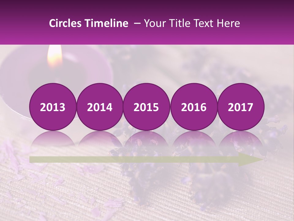 A Purple Candle And Some Lavender Flowers On A Table PowerPoint Template