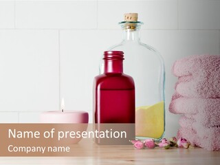 A Bottle Of Soap Next To A Pile Of Pink Towels PowerPoint Template