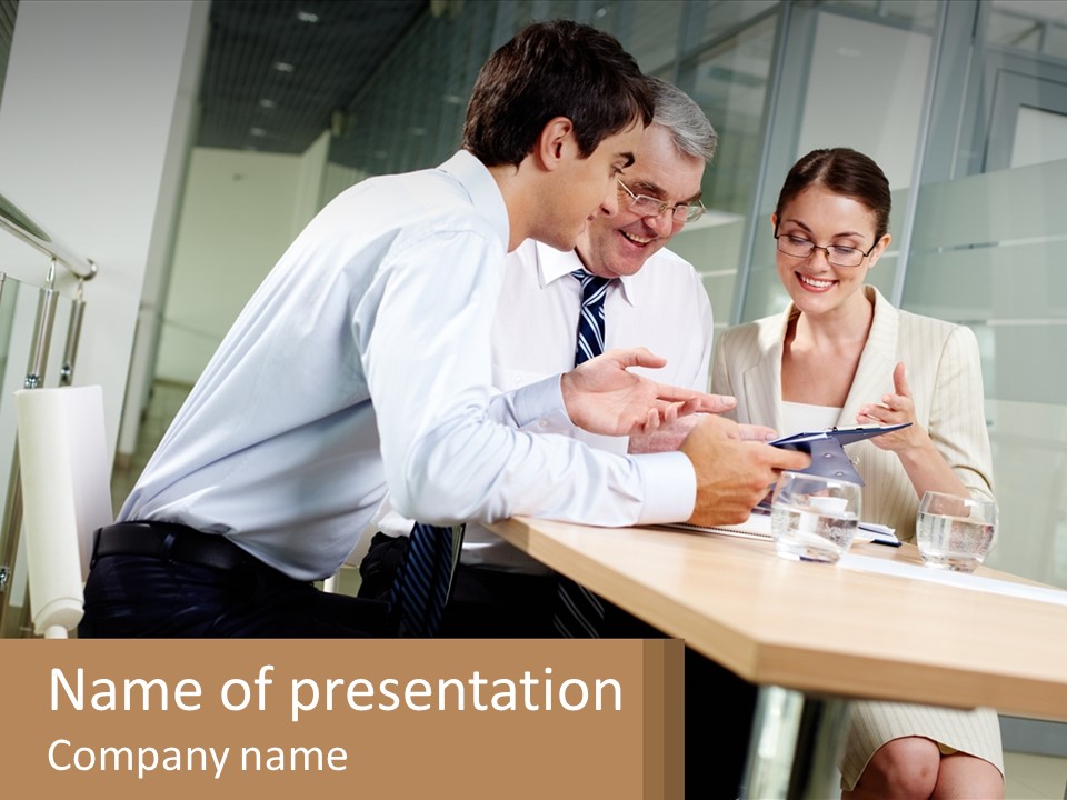 A Man And Woman Sitting At A Table With A Tablet PowerPoint Template
