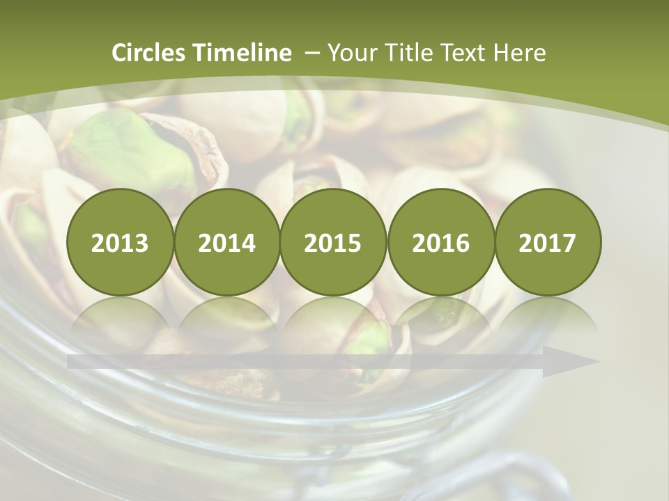 A Glass Jar Filled With Pistachios On Top Of A Table PowerPoint Template