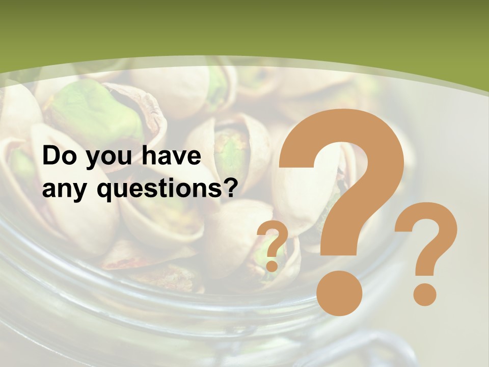 A Glass Jar Filled With Pistachios On Top Of A Table PowerPoint Template