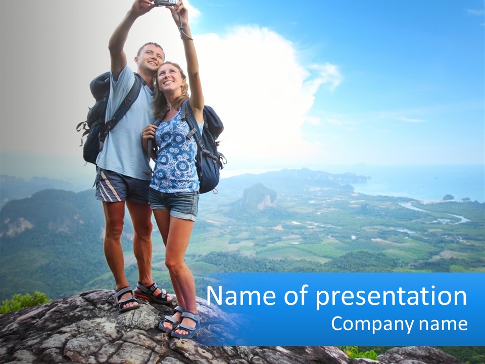 A Couple Of People Standing On Top Of A Mountain PowerPoint Template