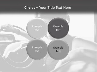 A Woman Sitting In A Car With Her Hand On The Steering Wheel PowerPoint Template