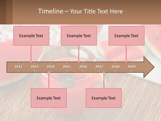 A Glass Of Watermelon Juice On A Table With Slices Of Watermelon PowerPoint Template