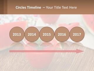 A Glass Of Watermelon Juice On A Table With Slices Of Watermelon PowerPoint Template