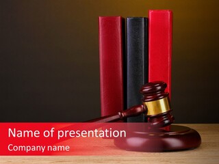 A Judge's Gaven Sitting On Top Of A Wooden Table PowerPoint Template