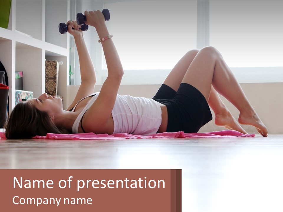 A Woman Laying On The Floor With A Dumbbell PowerPoint Template